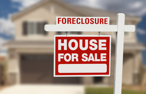 House with foreclosure sign outside